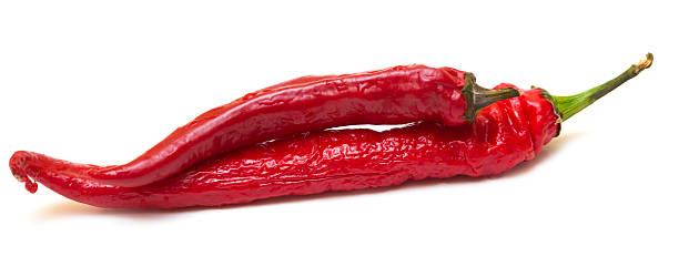 istock Red spicy peppers on white background 500119913