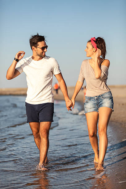 istock Happy Young Couple Walking Along Seashore 500120217