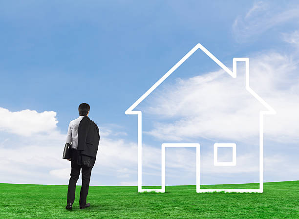 istock Man drawing house in a field 500120233