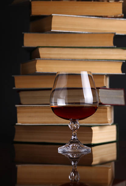 istock Glass of brandy and books 500122933