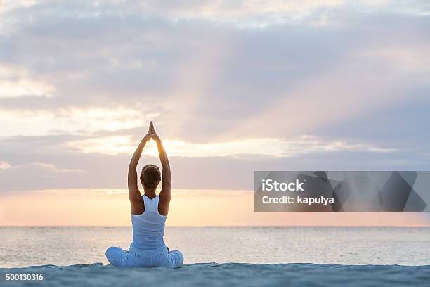 Caucasian Woman Practicing Yoga At Seashore Stock Photo - Download Image Now - Yoga, Beach, Women