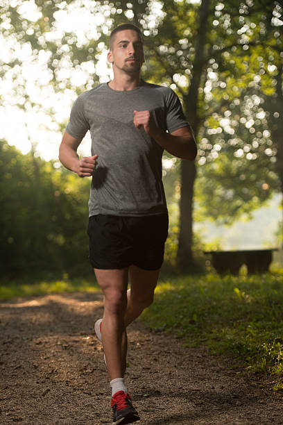 istock Male Runner Running City Park 500131064