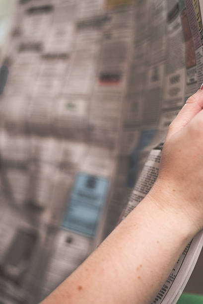 istock woman reading job section in newspaper 500132672