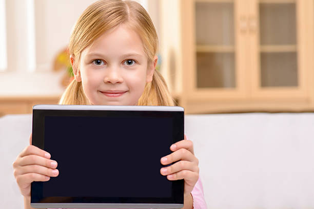 istock Joyful little girl holding tablet 500134056