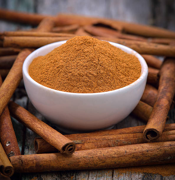 istock Cinnamon sticks and powder cinnamon in the bowl on table 500135640