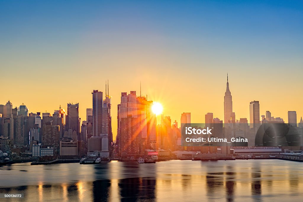 Midtown Manhattan skyline at sunrise Midtown Manhattan skyline at sunrise, as viewed from Weehawken, along the 42nd street canyon Sunrise - Dawn Stock Photo