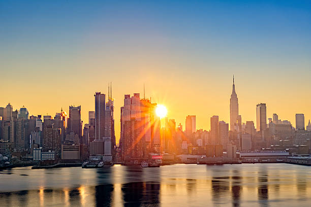 Midtown Manhattan skyline at sunrise Midtown Manhattan skyline at sunrise, as viewed from Weehawken, along the 42nd street canyon 42nd street stock pictures, royalty-free photos & images