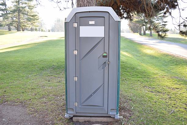 istock Porta Potty Green And Grey At Golf Course Under Tree 500136756