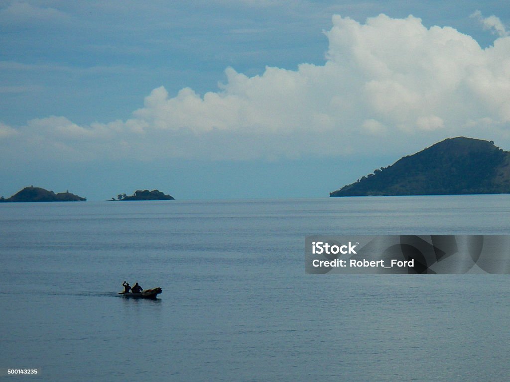 Fisherman on Lake Kivu Rwanda with Volcanic Islands in background Rwanda Stock Photo