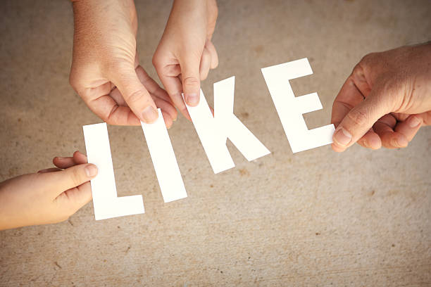 istock Like - Hands Holding White Letters Over Grunge Background 500145827