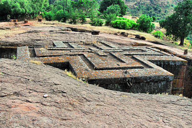 Lalibela, Ethiopia: rock-hewn Church of Saint George Lalibela, Amhara region, Ethiopia: rock-hewn Church of Saint George / Biete Giyorgis - seen from above - carved from red volcanic rock in the shape of a cross - 12th century - Ethiopian Orthodox Church - UNESCO world heritage site - photo by M.Torres the church of saint george lalibela ethiopia stock pictures, royalty-free photos & images