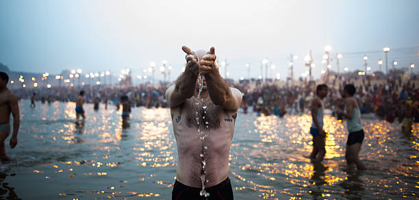 Hindu Pilgrim in Kumbh Mela Allahabad ,India – February 6, 2013: Hindu Pilgrims take a bath in Kumbh Mela,holy festival every 3 years.Believe whoever participates in this sacred festival will go to heaven  prayagraj photos stock pictures, royalty-free photos & images