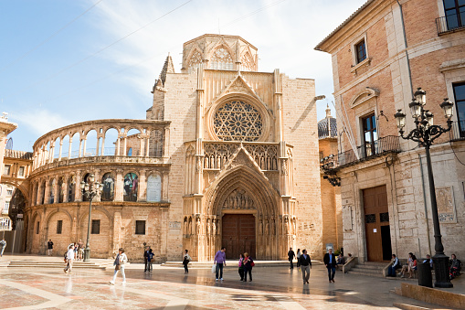 Valencia, Spain - April 10, 2013: Virgin square with Apostles Gate of the Valencia cathedral. The Cathedral is a place where one of the supposed Holy Chalices is kept.