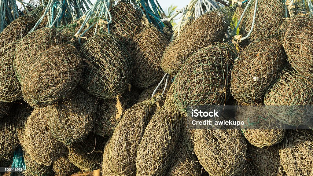 Fisherman net wrapped in small bundle. Close up. Fishing net used by Asian fisherman being wrapped, hung and dried on a tree. Close up. Abstract Stock Photo