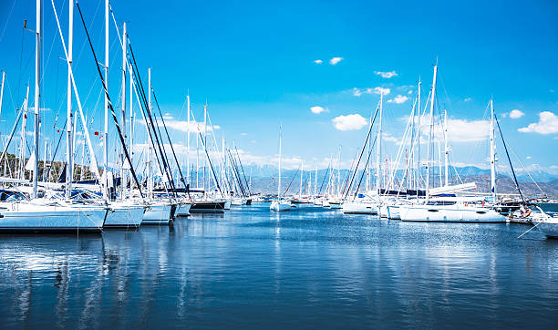 Sail boat harbor Sailboat harbor, many beautiful moored sail yachts in the sea port, modern water transport, summertime vacation, luxury lifestyle and wealth concept Marina stock pictures, royalty-free photos & images