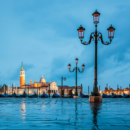 Gondolas floating in the Grand Canal on a cloudy day, Venice, Italy.