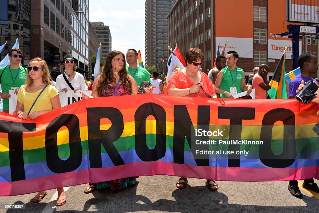 World Pride Parade Toronto Toronto, Canada - June 29, 2014:  WorldPride parade participants hold the Toronto banner for start of the closing parade. Toronto was the first North American city to host the event Gay Pride Parade Stock Photo