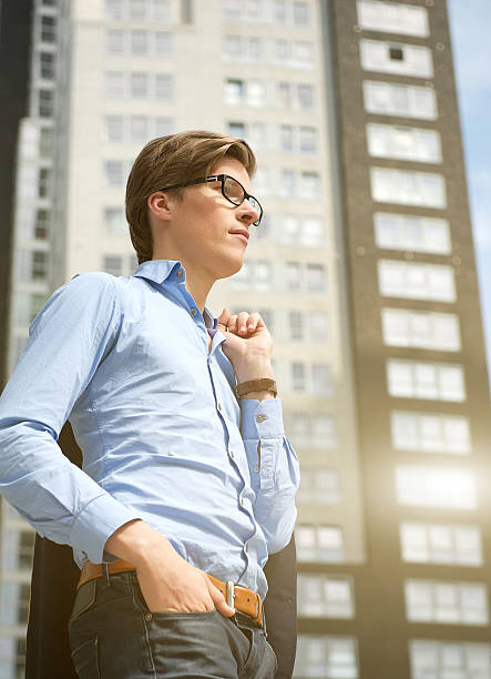businessman standing next to building