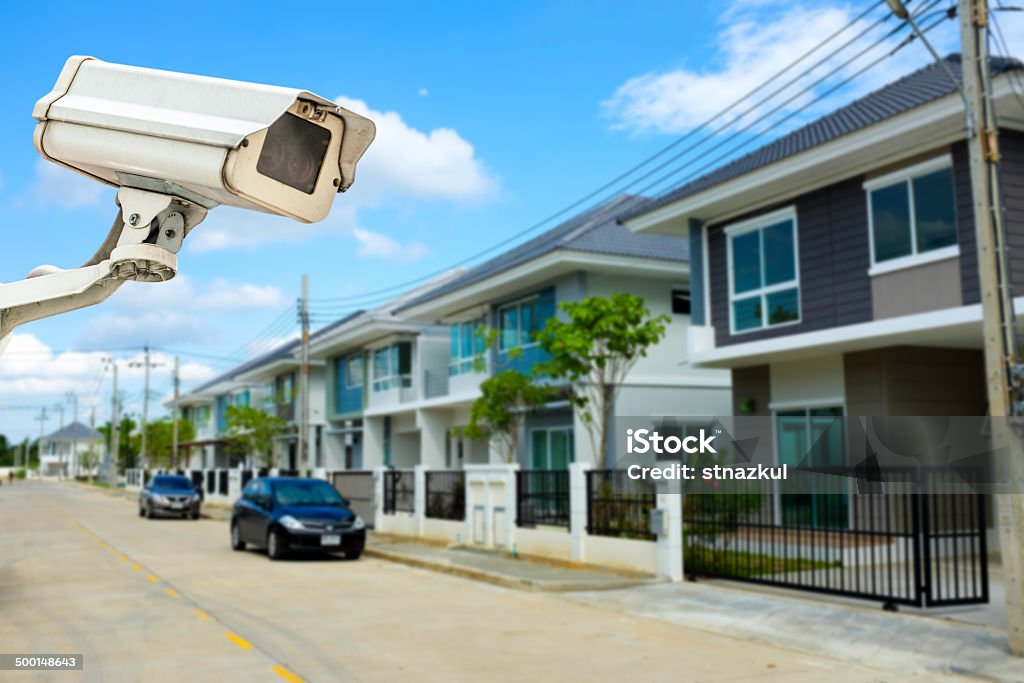 CCTV Camera or surveillance with village in background Above Stock Photo