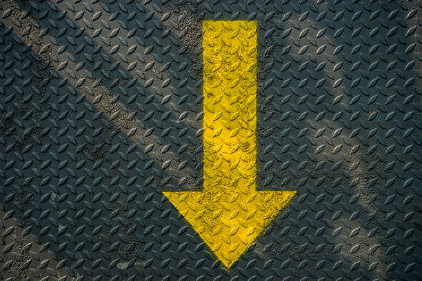 istock Yellow down arrow and steel background 500156748