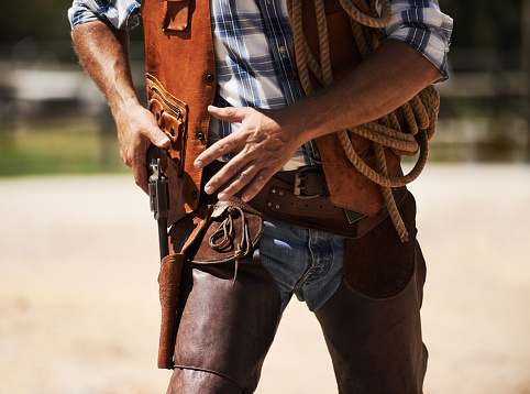 Cropped shot of an unrecognizable cowboy drawing his gunhttp://195.154.178.81/DATA/i_collage/pi/shoots/783508.jpg
