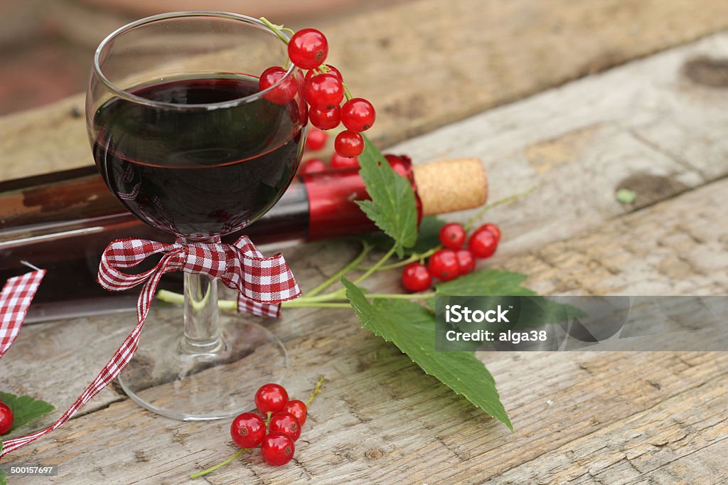 Red currant wine in glass on wooden background Alcohol - Drink Stock Photo