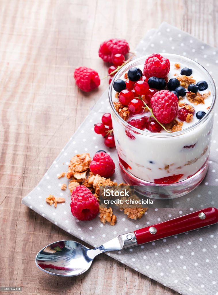 Healthy breakfast Healthy breakfast, yogurt with granola and berries in the glass on the wooden table Berry Fruit Stock Photo