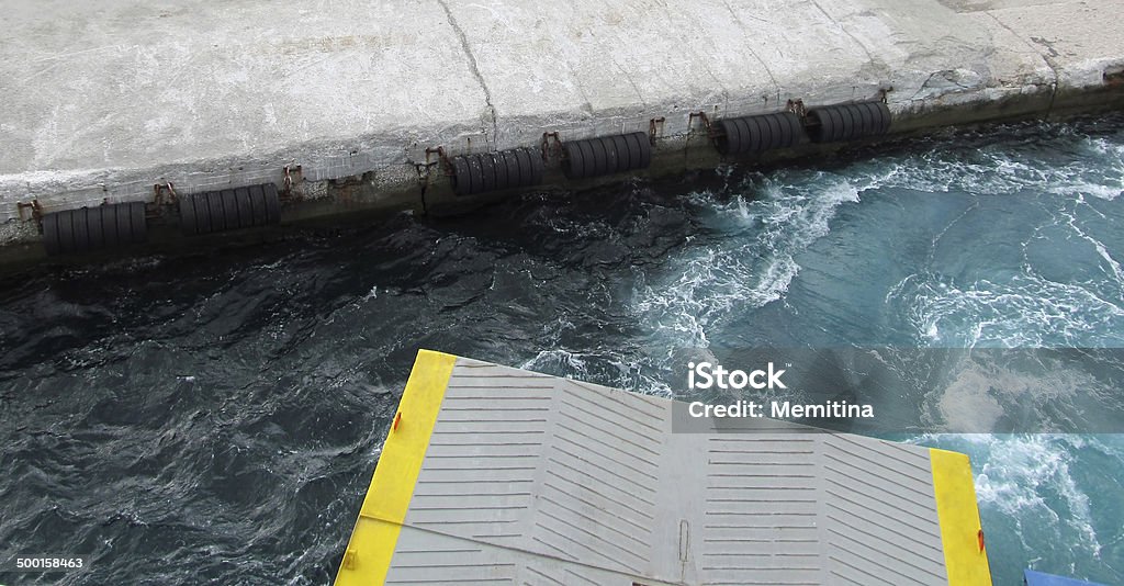 ferry arrival ferry boat hatch while approaching the concrete dock Bumper Stock Photo