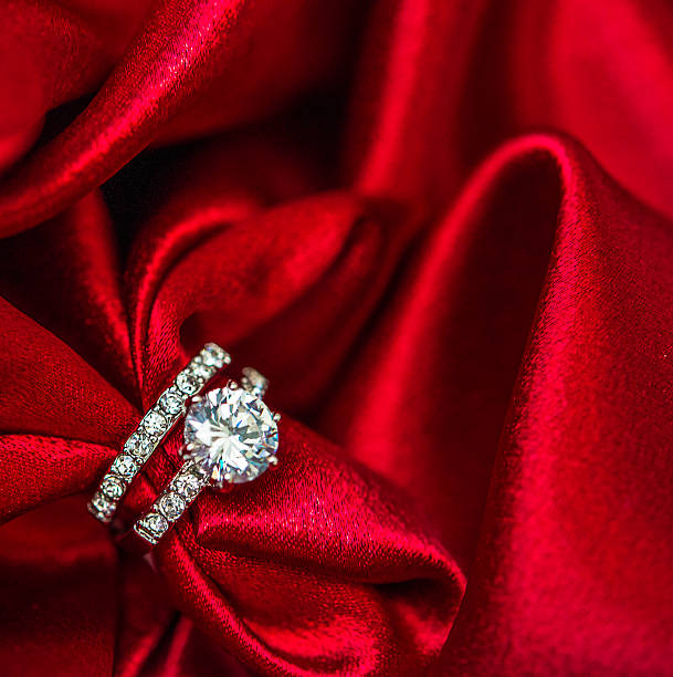 istock Wedding and engagement rings in rich red satin 500159386