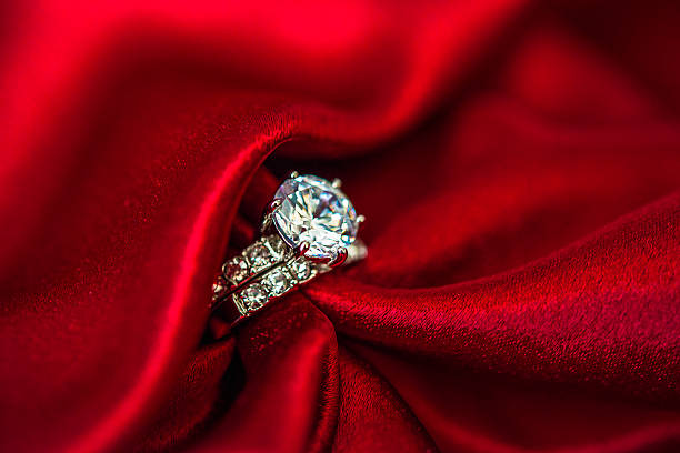 istock Wedding and engagement rings in rich red satin 500159464