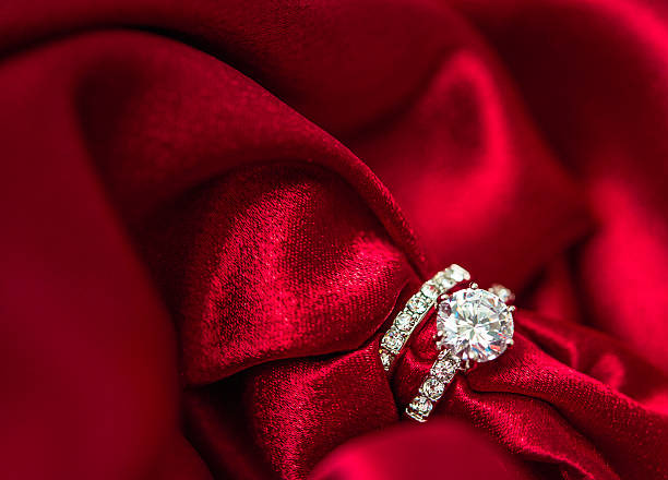 istock Wedding and engagement rings in rich red satin 500159660