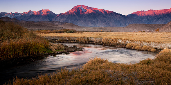 Alpenglow at dawn over California's Sierra Nevada mountains in the Owens River Valley.