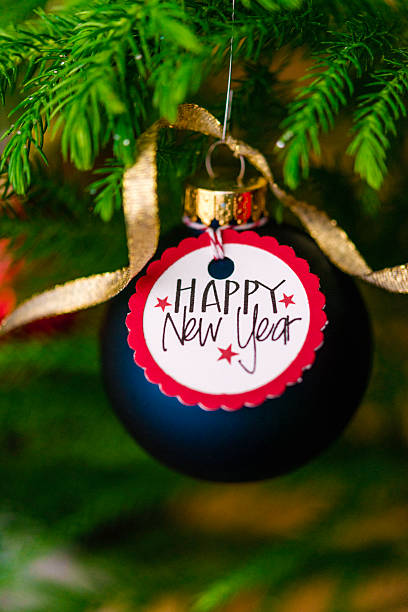 istock Christmas bauble with New Year message on Christmas tree branches 500159948