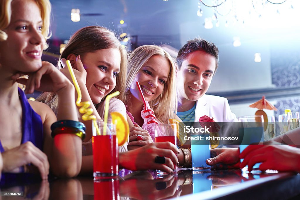 Friends in the bar Portrait of happy friends with cocktails having rest in bar Adult Stock Photo