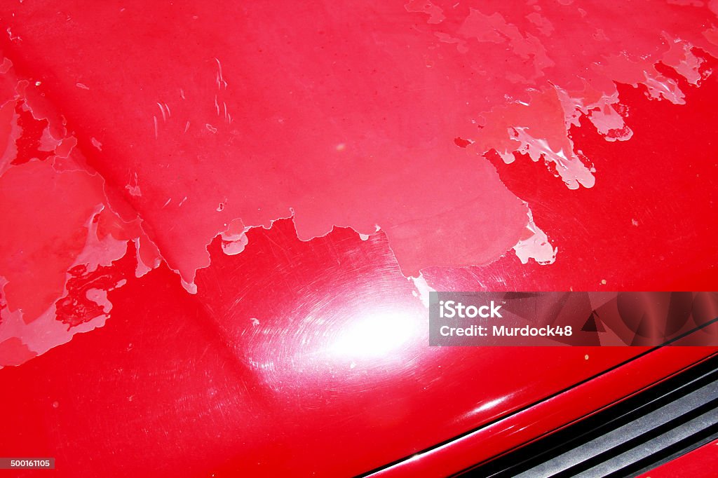 Peeling car Paintwork Peeling car paintwork on a red car Blue Stock Photo