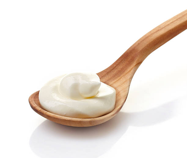 istock cream in a wooden spoon 500161477