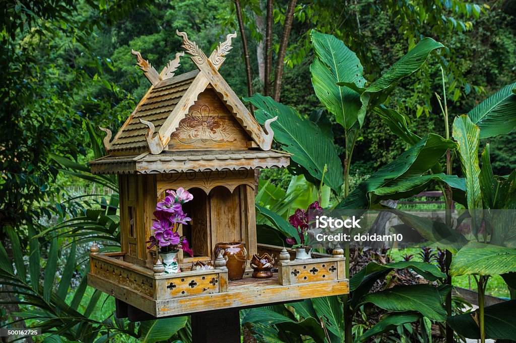 spirit house in thailand with flowers spirit house in thailand with flowers in vases and some wreathes, house joss. Art Stock Photo