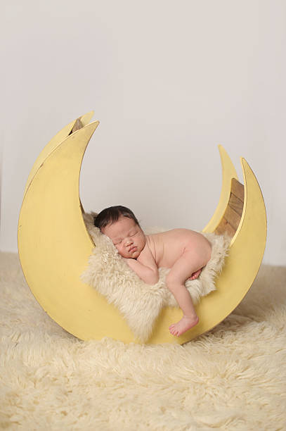 istock Newborn Boy Sleeping Peacefully on Moon Prop 500163807