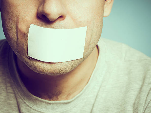 istock Caucasian man with duct tape on mouth, white . 500171010
