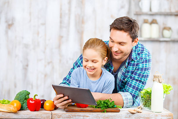 istock Happy father and daughter cooking together 500173198