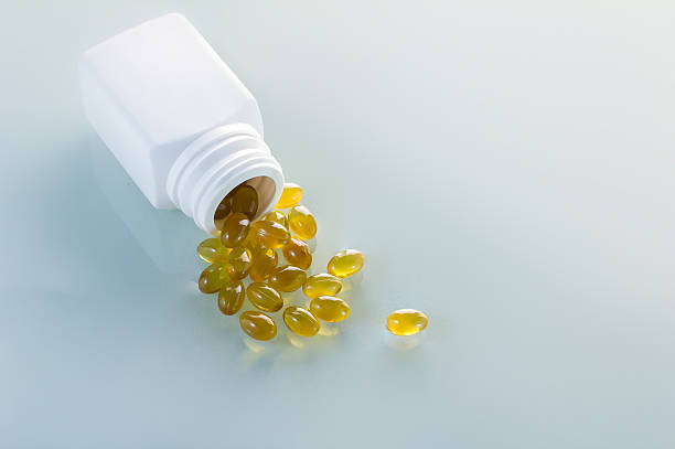 istock oil capsules in white bottle 500173526