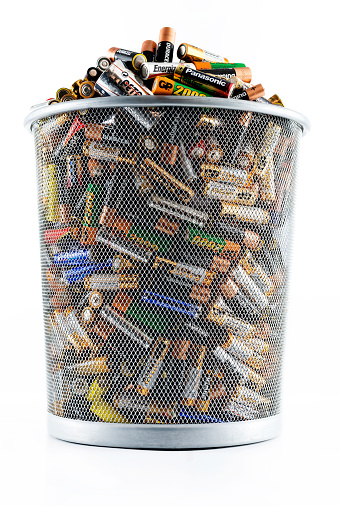 Istanbul, Turkey - July 2, 2014: Non-rechargeable AA size batteries in garbage can. Brands include Philips, Duracell, Panasonic, Ikea, Sony, GP.