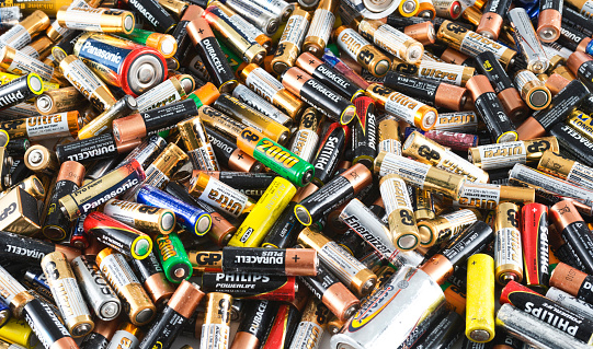 Istanbul, Turkey - July 2, 2014: Large collection of non-rechargeable AA size batteries piled. Brands include Philips, Duracell, Panasonic, Ikea, Sony, GP.