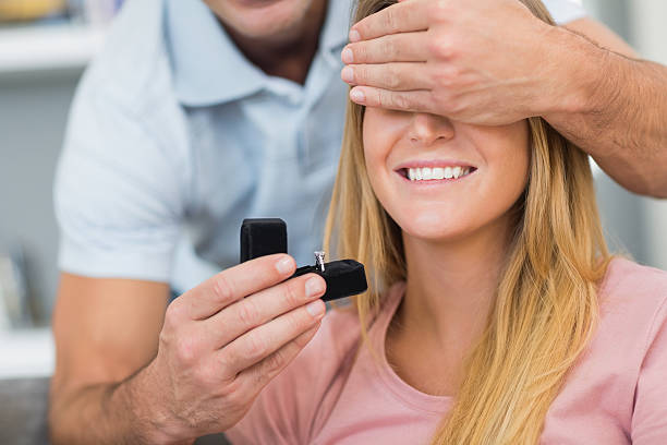 istock Man about propose to his unsuspecting girlfriend on the couch 500174537