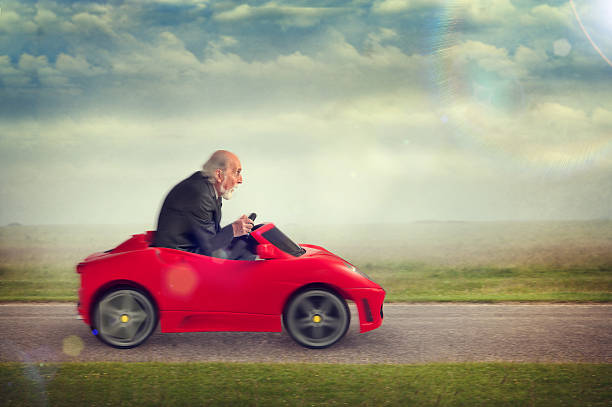 istock senior man driving a toy racing car 500175535