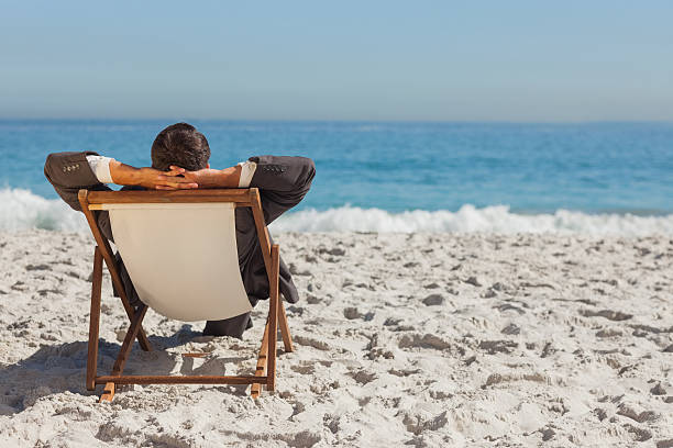 istock Young businessman relaxing on his sun lounger 500176471