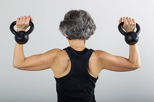 istock Middle Aged Female Sports Trainer With Kettle Bells 500176679