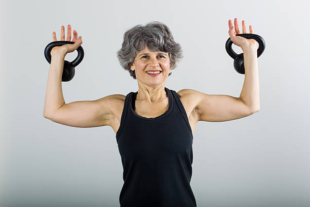 istock Middle Aged Female Sports Trainer With Kettle Bell 500176683
