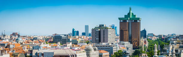 Madrid downtown cityscape rooftop panorama highrises and offices Spain Panoramic view across the rooftops of central Madrid to the business district skyscrapers, Torre de Colon and blue sky horizon beyond, Spain. ProPhoto RGB profile for maximum color fidelity and gamut. contemporary madrid european culture travel destinations stock pictures, royalty-free photos & images