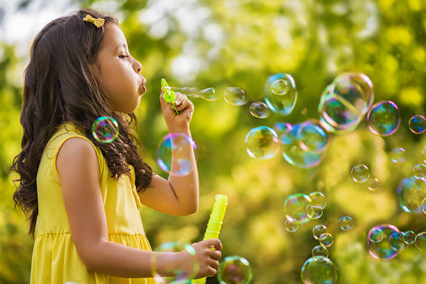 istock Little girl blowing soap bubble 500179267